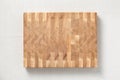 Oak spliced Ã¢â¬â¹Ã¢â¬â¹wooden cutting board on burlap. The cross-section of the oak plank has a mosaic texture.